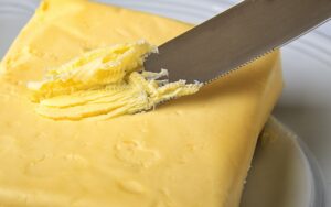 butter being spread by a bread knife