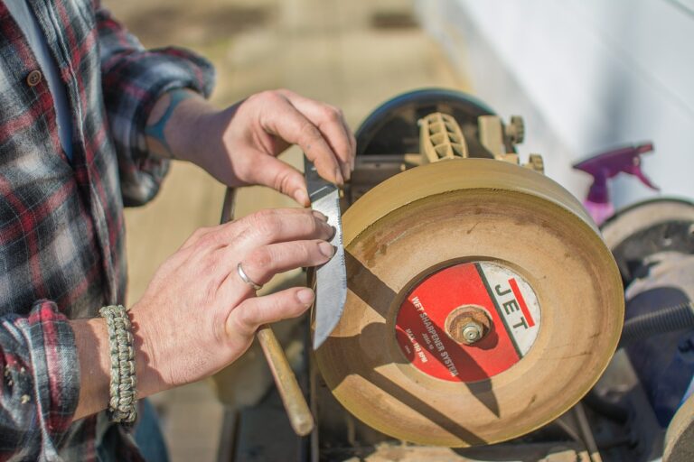 man using an electric knife sharpener